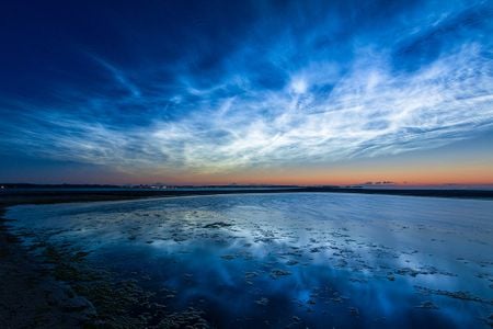 Noctilucent clouds over the Baltic Sea, as seen from Germany in 2019. Typically seen in polar regions, the clouds are increasingly appearing at mid- and low latitudes.