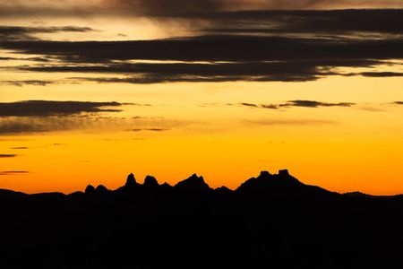 A sunet behind the mountains in what is now the Avi Kwa Ame National Monument in Nevada