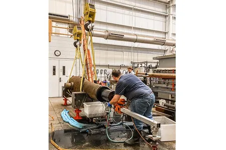 Erik Farrell stands beside one of the USS Monitor's eight-ton, Civil War-era Dahlgren guns. 