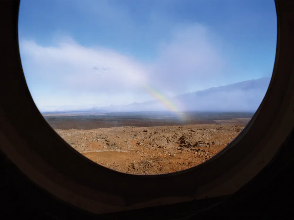 A rainbow on rugged landscape