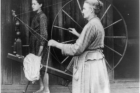 An unknown woman spinning, circa 1900.