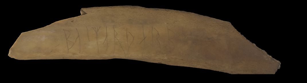 A piece of bone with runes carved into its surface