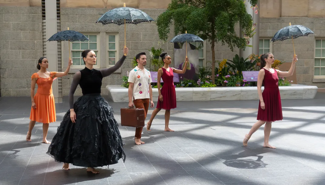 Image of several dancers with parasol in Portrait Gallery courtyard