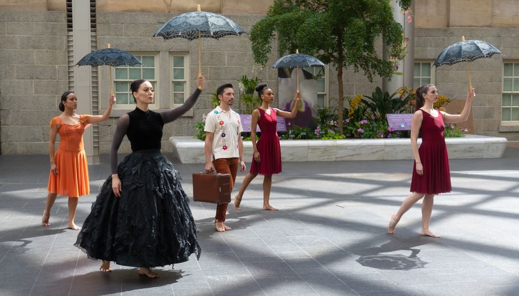 Image of several dancers with parasol in Portrait Gallery courtyard