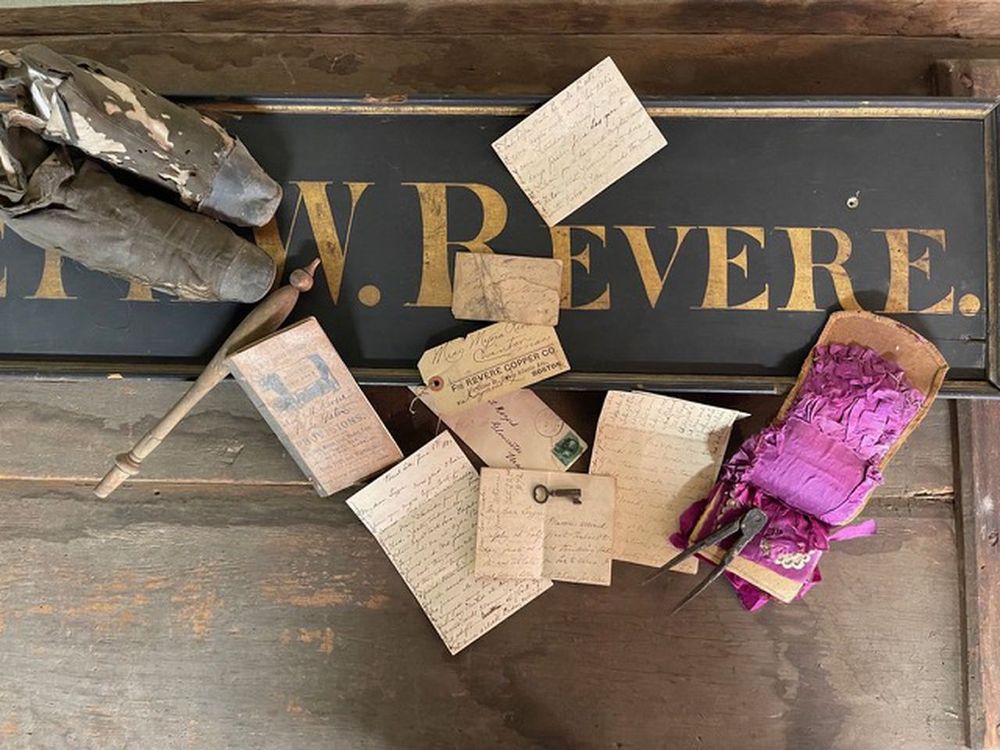 Letters and documents on top of the trade sign bearing the name Joseph W. Revere