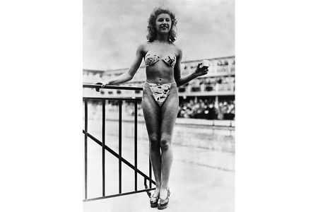 Nude dancer Micheline Bernardini models the first bikini in Paris, France.