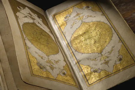 The manuscript features an array of gilded designs and illustrations.