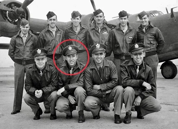 Black and white photo of soldiers with a red circle around one of their faces