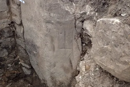 This inverted cross was likely carved on the inn's hearth stone in hopes of discouraging witches from flying down the chimney