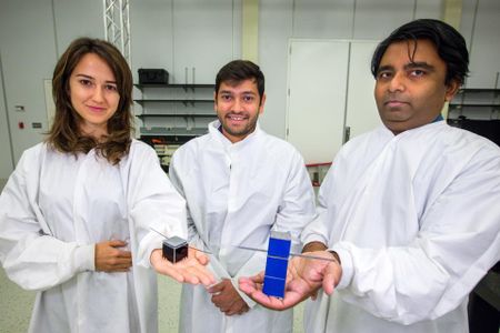 Jekan Thanga (right) and students holding FemtoSats