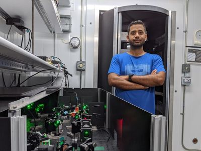 Physicist Avinash Kumar of Simon Fraser University stands beside the Mpemba effect apparatus.