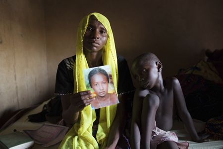 Rachel Daniel, mother of one of the abducted Nigerian school girls, holds up a picture of her still-missing daughter. 