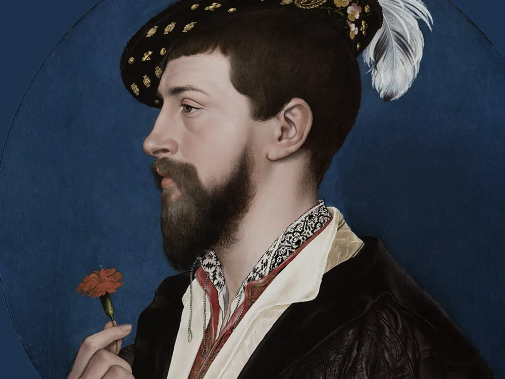A circular portrait of a pale man with dark hair and beard, side profile, wearing a feathered hat and holding a red flower in one hand