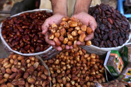 A vendor offers dates for sale on a roadside, as Muslims across the world prepare for the holy month of Ramadan, in Peshawar, Pakistan.