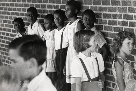 In July 1955, black children wait to register for school in Lawrence County, Arkansas, as schools desegregate in the wake of Brown v. Board of Education. 