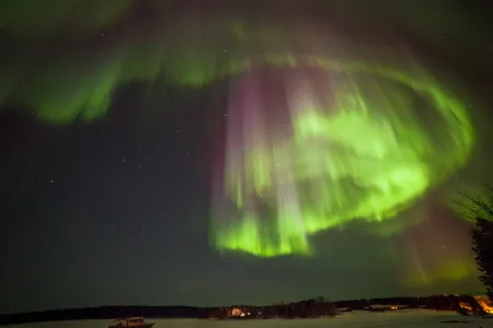 an aurora borealis over Lake Inari in Finland