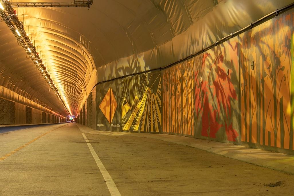 Mural on wall inside dimly lit tunnel
