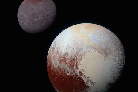 This composite image features Pluto and its largest moon Charon in enhanced color.