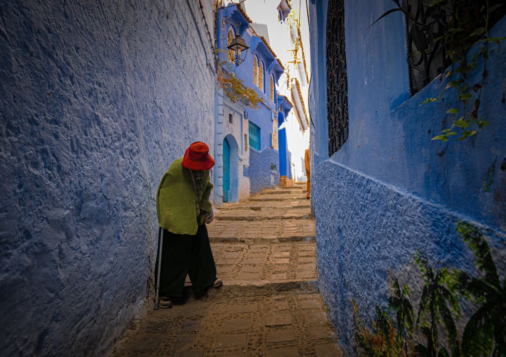 Chefchaouen is a city in northern Morocco, highlighted by its white-washed and blue painted buildings. I saw this woman walking down the steps of an alley while visiting the town, and I was awe-struck by the contrast between her colorful outfit and the blue walls.