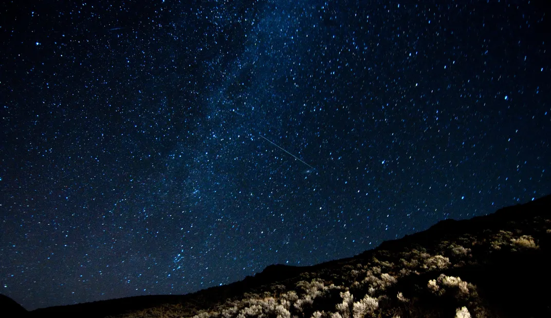 two streaks of draconid meteors in a starry sky