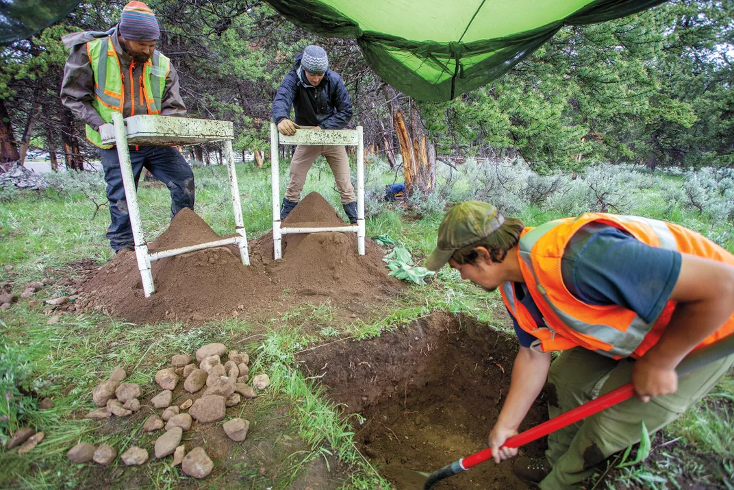 Scott Dersam and Bradan Tobin sift soil through screens to recover artifacts.