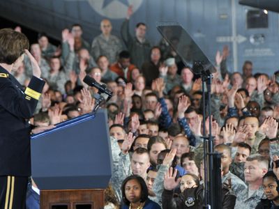 Army Reserve members raise hands