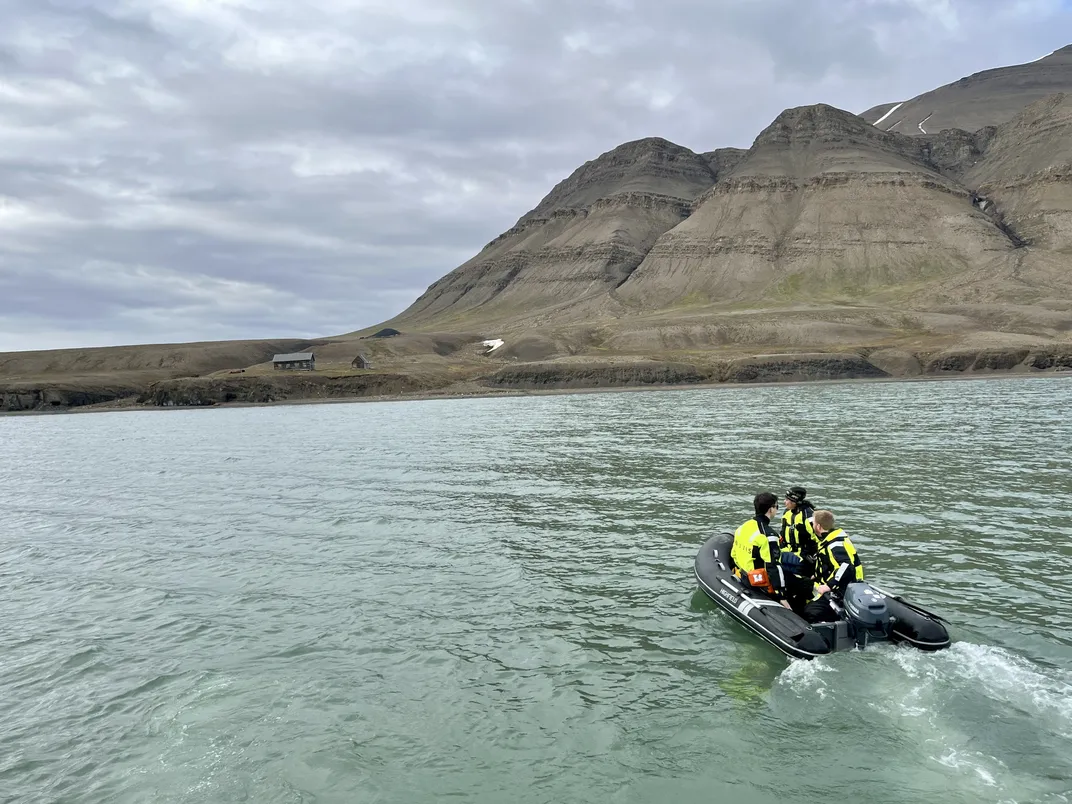 researchers take a small lifeboat toward land