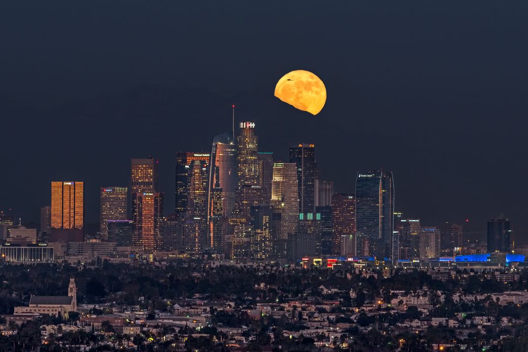 LA Skyline at night with the moon in background