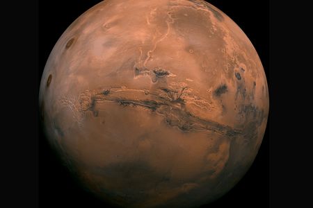 In 1980, the Viking Orbiter took 102 individual images of Mars that scientists eventually assembled into this stunning composite photo. The dark gash across the planet&rsquo;s face is the Valles Marineris, a canyon that&rsquo;s up to 6 miles deep and over 2,500 miles long.