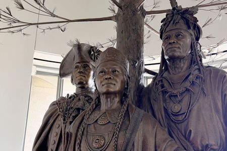 Detailed photo of a bronze sculpture depicting George Washington, Polly Cooper, and Skenandoah from the waist up.