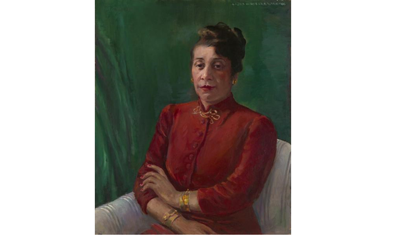 Distinguished in a high-collared, red shirt and gold jewelry, Alma Thomas wears her hair up and looks directly at the viewer. Her arms are crossed loosely, and she sits before a green background.