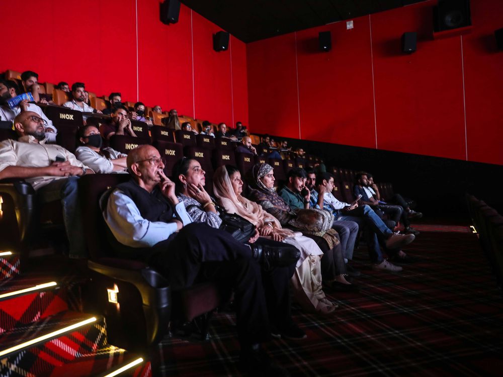 Members of the media and other guests watch the first show of a Bollywood movie Vikram Vedha inside Kashmirs first-ever multiplex 'INOX' on September 30, 2022 in Srinagar, India