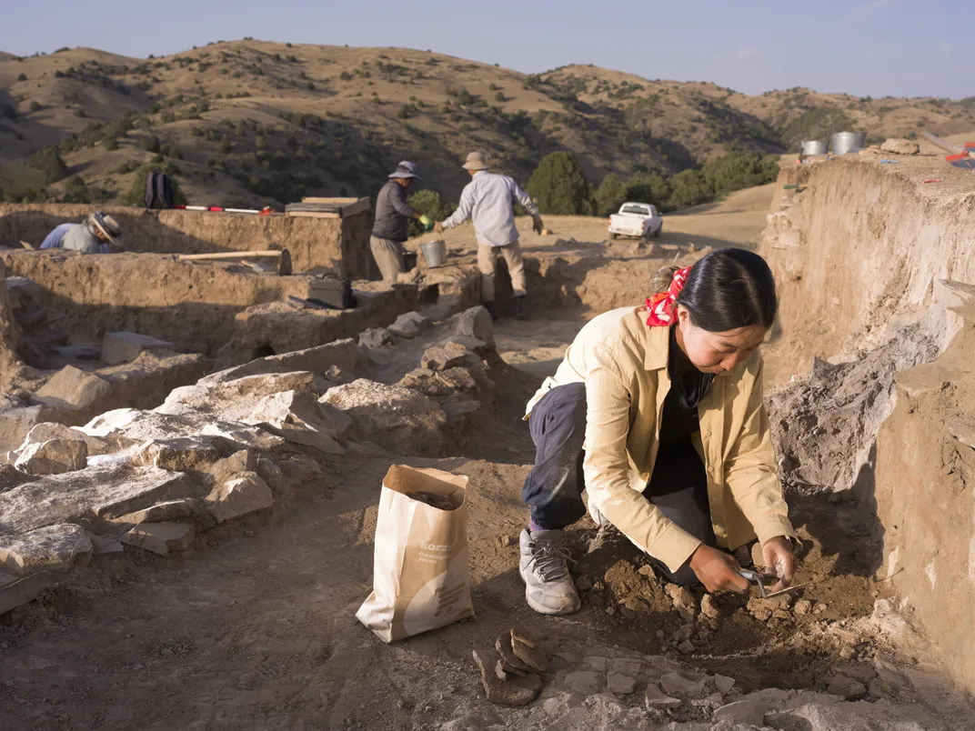 Field co-supervisor Mirae Jo, a PhD student at Washington University in St. Louis, excavates ceramic scatter at Tugunbulak. Jo studies how high-altitude civilizations used artificial water systems.