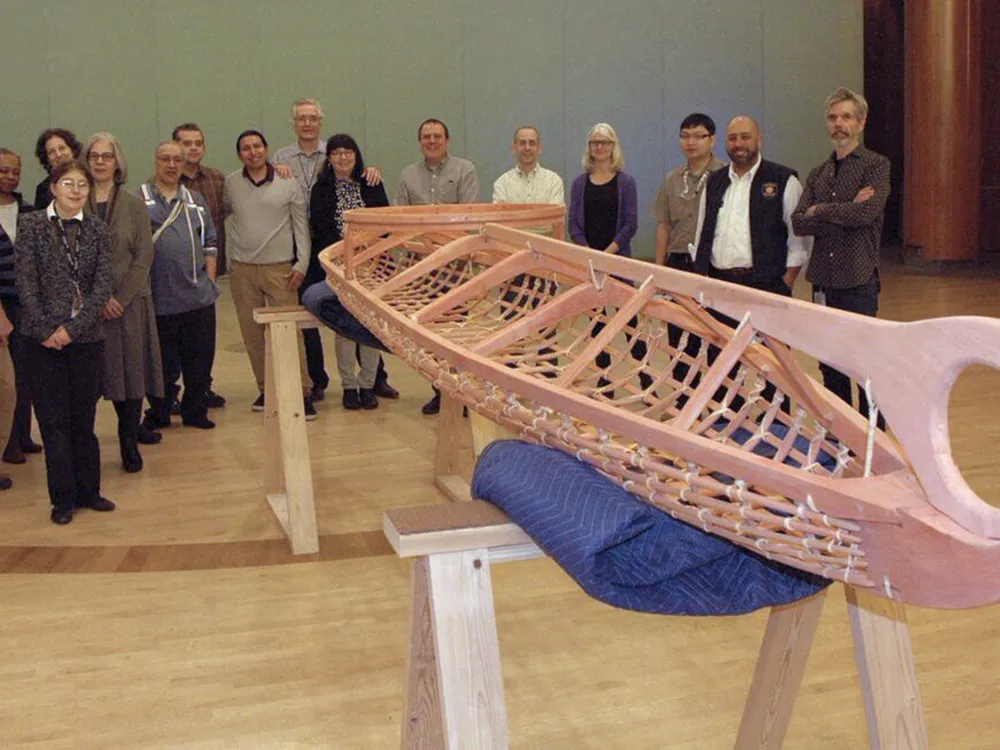 Members of the staff of the National Museum of the American Indian in New York hold a welcoming ceremony for a kayak frame built in the traditional Yup'ik way at the Qayanek Qayak Preservation Center in Kwigillingok, Alaska. A testament to the ingenuity and innovation of the Native cultures of the Arctic, the kayak frame will become a teaching exhibit when the New York museum's imagiNATIONS Activity Center opens this May. (National Museum of the American Indian, Smithsonian)