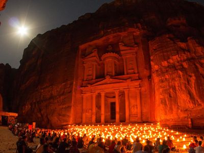 Visitors sit in front of Petra's famous temple at night. Nearby, Google Earth and drones helped researchers find a previously undiscovered platform probably used for ceremonial purposes.