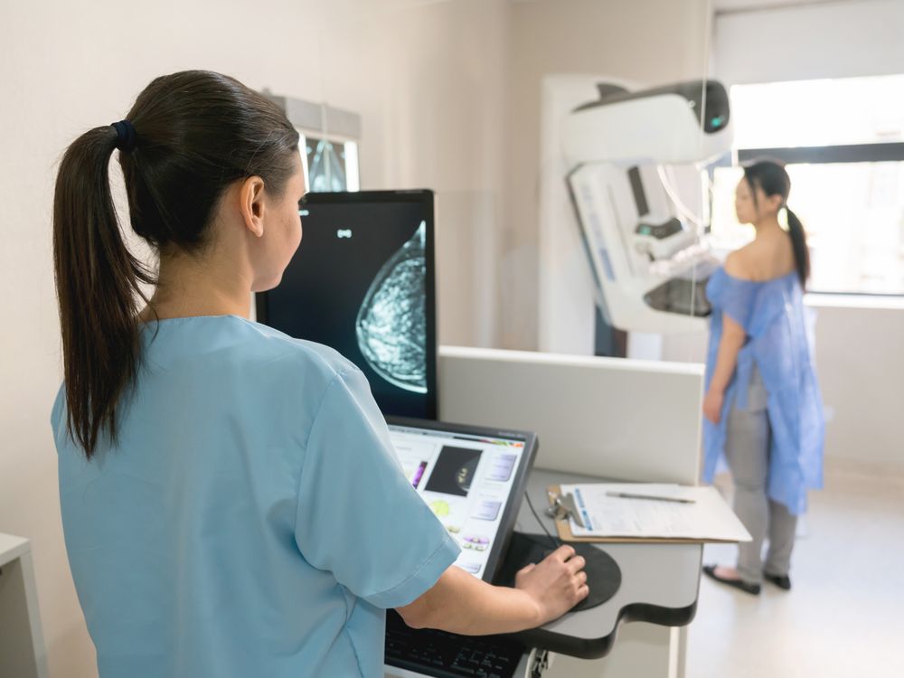 A nurse administering a mammogram