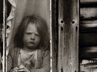 A young Walden resident, circa 1974, appears none too happy about being kept inside, or having her picture taken.
