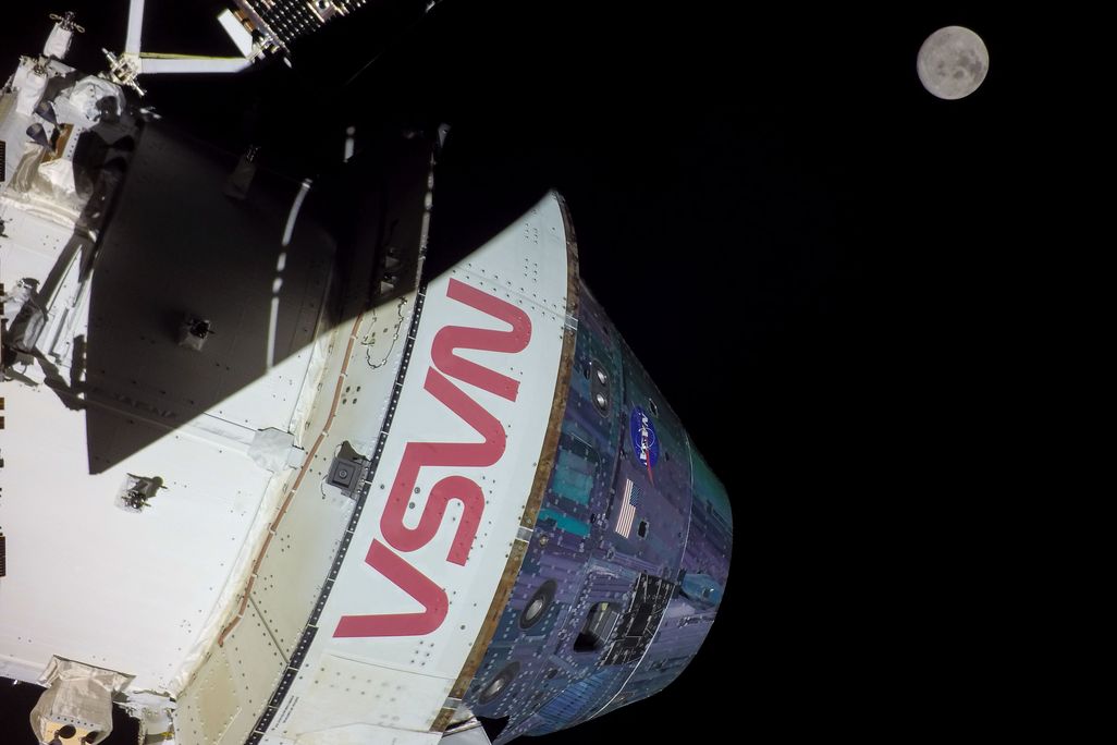 A photo of NASA's Orion spacecraft, with the moon in the background