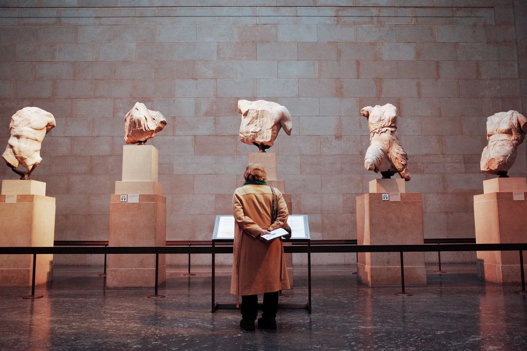 A woman looks at the Parthenon sculptures/Elgin marbles in the British Museum, London