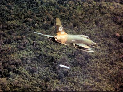 A North American F-100D Super Sabre drops a napalm bomb near Bien Hoa, South Vietnam, 1967.