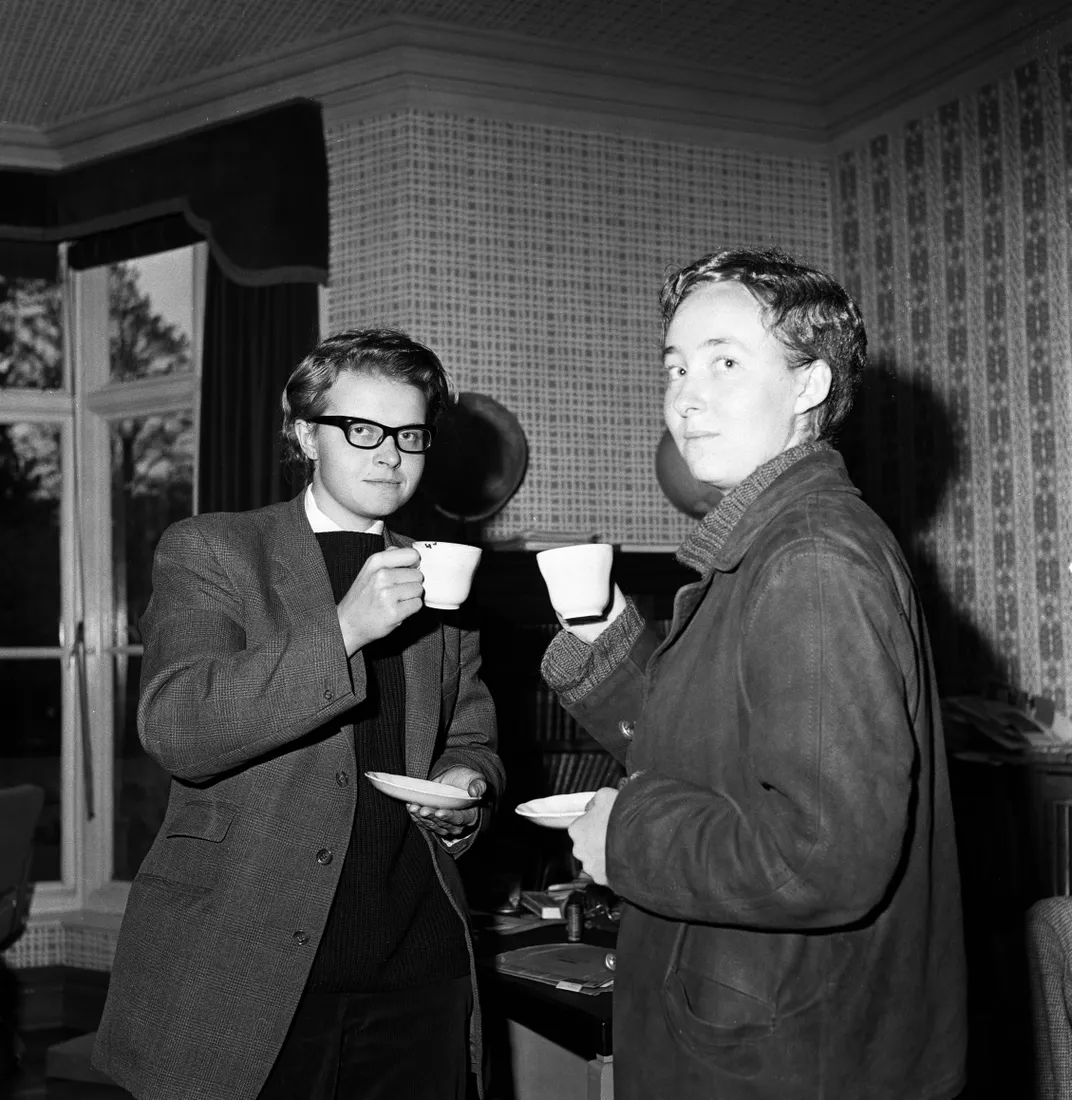 Dugdale (left), disguised as man, has tea with fellow student Jennifer Grove (right) before attending a debate at the Oxford Union Society in 1961