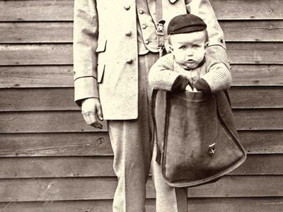 Uniformed Letter Carrier with Child in Mailbag