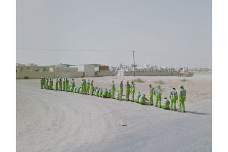 A line of men in green in the United Arab Emirates