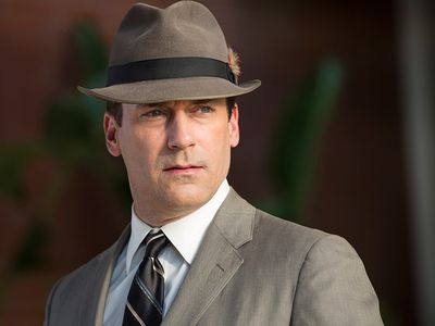 Actor Jon Hamm sporting the iconic fedora and gray suit of his alter ego, Don Draper, from the popular television show "Mad Men." Draper's suit and fedora, along with Betty Francis' yellow housedress and other props were donated to the Smithsonian.