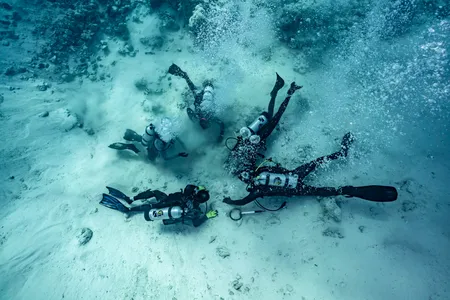 Divers from AllenX examines the debris trail of the Maravillas, which sank in the Bahamas in 1656.