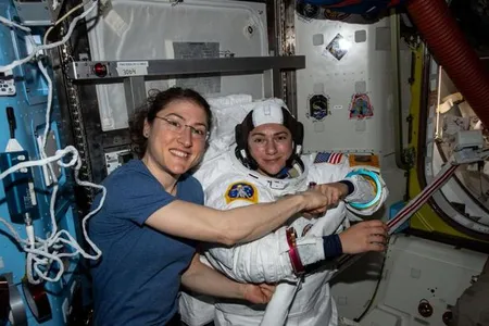 Christina Koch (left) poses for a portrait with Jessica Meir while preparing for their first spacewalk together.