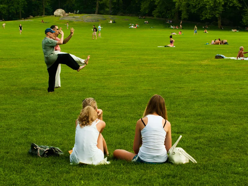 People in a park of New York city practicing their own activities ...