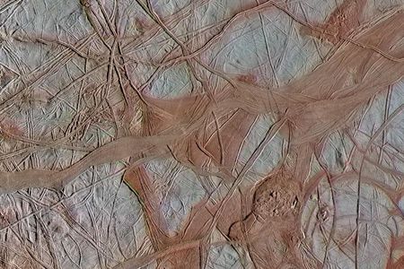 Underneath the cracked ice of Jupiter's moon Europa, there is likely a global ocean. Bluish ice in this Galileo spacecraft image is more pure water ice, while the reddish areas are ice mixed with other substances.