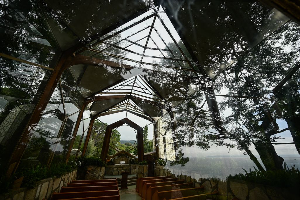 Glass-enclosed chapel with trees around it