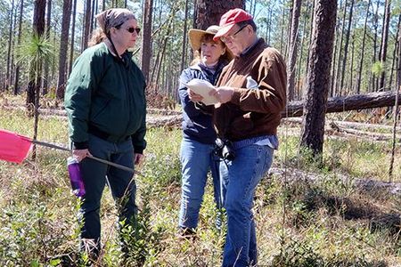 Archeologist Rhonda Kimbrough (left) discusses the survey strategy at Prospect Bluff with author and historian Dale Cox and SEAF Treasurer Janet Bard